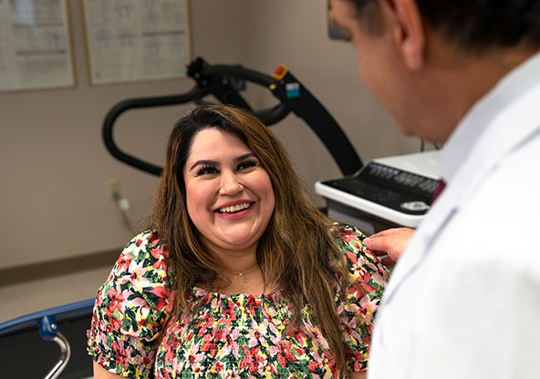 Crystal talking with her doctor, discussing recovery and next steps after postpartum cardiomyopathy.