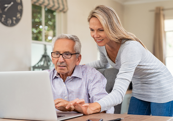A daughter helping her father fill out a health risk assessment