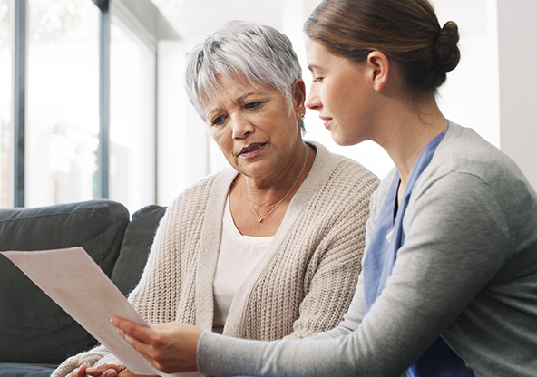 A elder Hispanic lady listening to her physician about her calcium score report